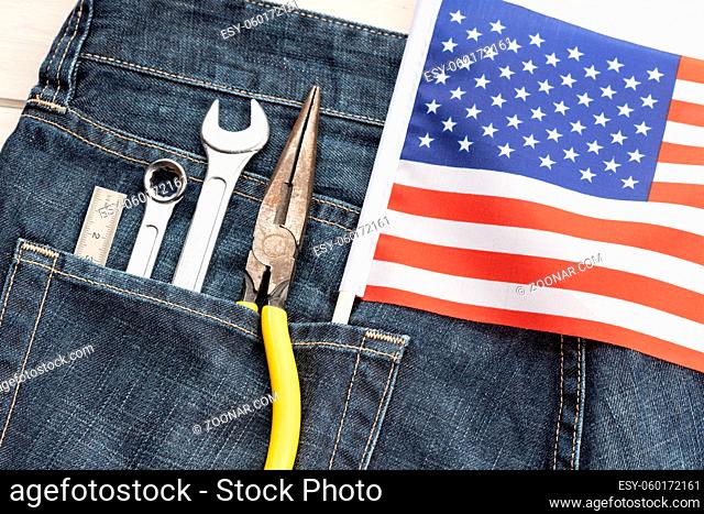 Set of tools and american flag in jeans pocket. Labor day background concept