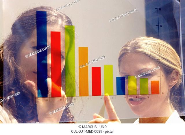 Two young women seen through graph