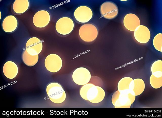 Yellow defocused lights over a soft blue and pink background