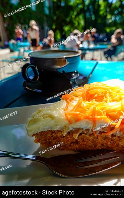 Stockholm, Sweden A slice of carrot cake and a cappuccino coffee on a table at an outdoor café. | usage worldwide. - STOCKHOLM/Sweden