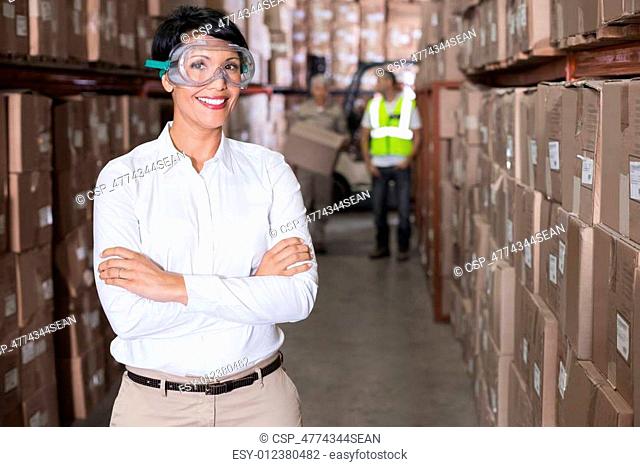 Pretty warehouse manager smiling at camera