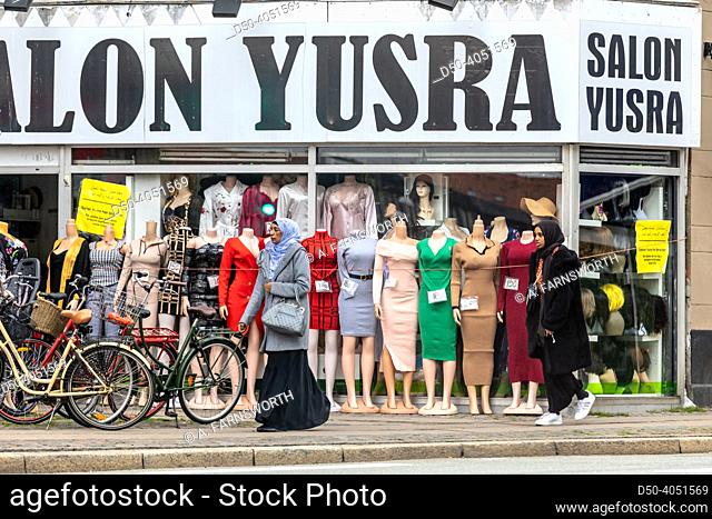 Copenhagen, Denmark Middle eastern womaen wwearing veils walk by a store in Norrebro selling middle eastern women's clothes