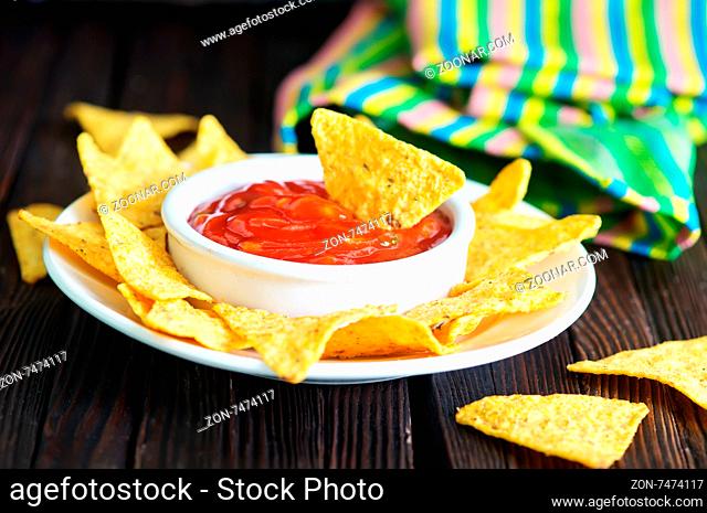 nachos with sauce on the white plate
