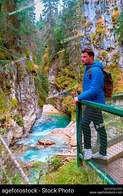 Beautiful Johnston Canyon walkway with turquoise water below, in Banff National Park, Alberta, Canada, lovely blue river