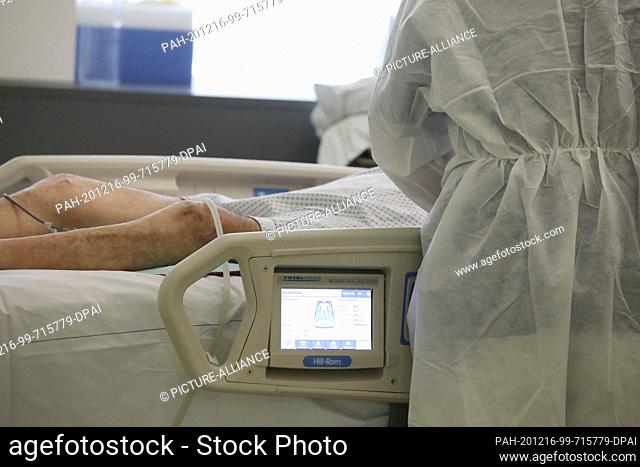 16 December 2020, Thuringia, Gera: A patient lies on a hospital bed in the Covid 19 intensive care unit at SRH Waldklinikum