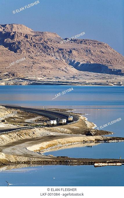 Trucks on road skirting the perimeter of the Dead Sea, En Bokek, Israel, Middle East