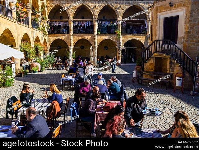 CYPRUS, NICOSIA - DECEMBER 14, 2023: Citizens visit a cafe at Buyuk Han, a 16th-century caravanserai (roadside inn). The Turkish Republic of Northern Cyprus is...