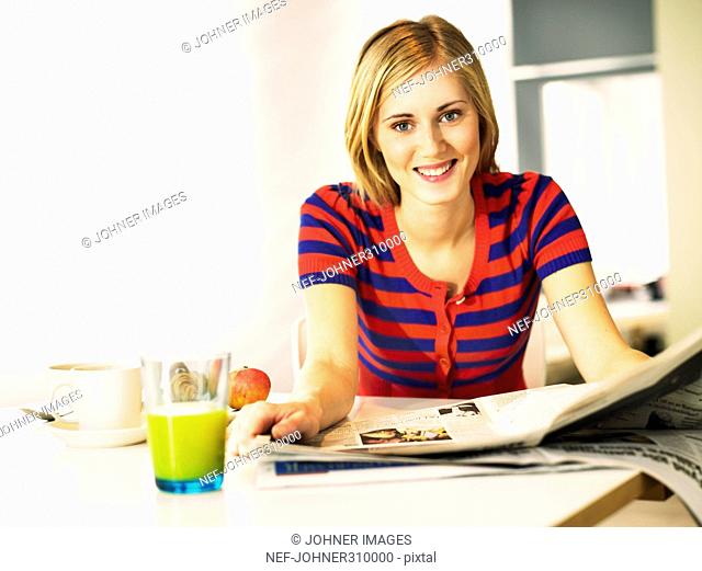 A smiling woman at the breakfast table