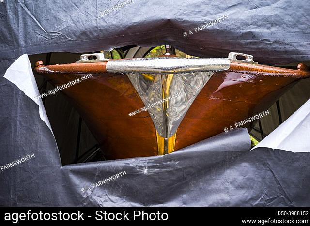 Stockholm, Sweden A classic old wooden boat and shiny focsle underneath a plastic covering