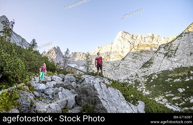 Two hikers look over mountains, hiking to the Hochkalter, Berchtesgaden Alps, Berchtesgadener Land, Upper Bavaria, Bavaria, Germany, Europe