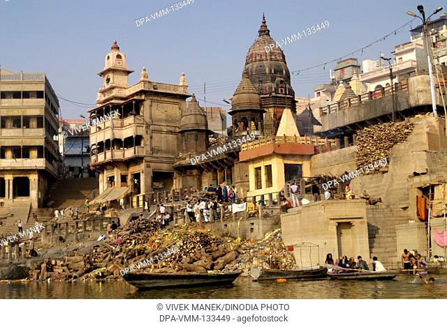 Hindu cremation ceremony at Manikarnika ghat on banks of holy Ganga river ; Varanasi ; Uttar Pradesh ; India