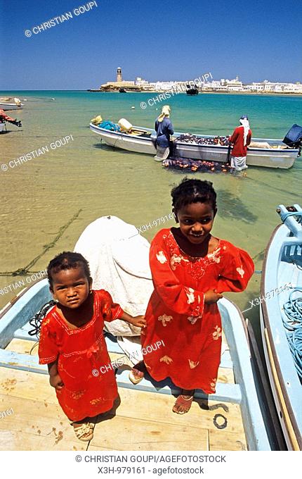 young girls standing up on fishing boat , Sur, Sultanate of Oman, Arabian Peninsula, Asia