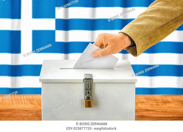 man putting ballot in the ballot box - greece
