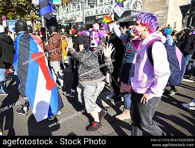 16 October 2021, North Rhine-Westphalia, Duesseldorf: Participants of the Christopher Street Day rally march through the city center