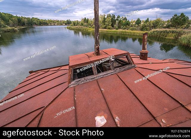 Roof of sinking boat on a Yanov backwater in Pripyat ghost city of Chernobyl Nuclear Power Plant Zone of Alienation in Ukraine