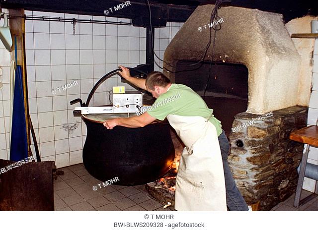 traditional cheese production: fire for heating the milk in a big kettle, Switzerland, Valais, Taeschalp, Zermatt