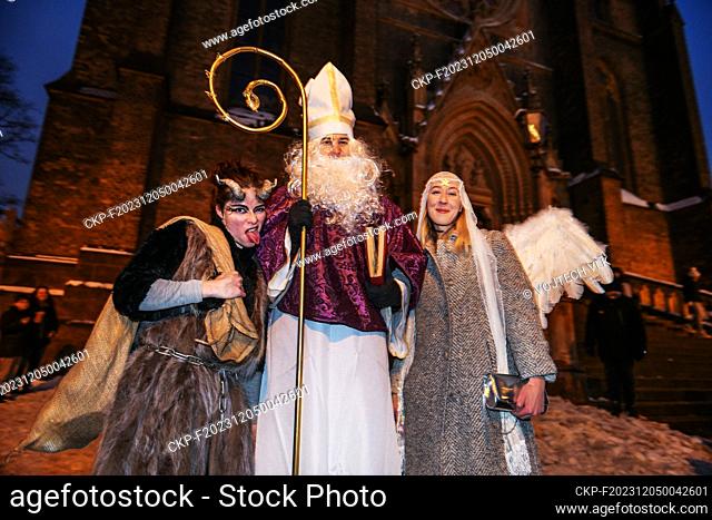 Nicholas, the devil and an angel pose in front of the church in Prague, Czech Republic, December 5, 2023. (CTK Photo/Vojtech Vlk)