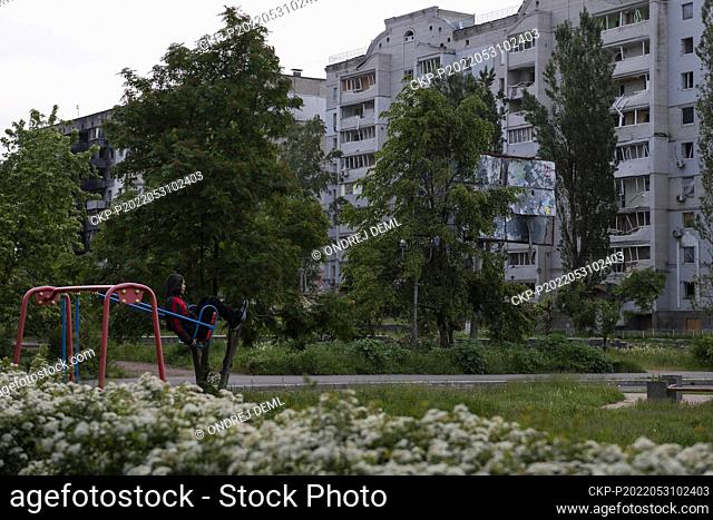 Boy on the playground in front of the destroyed apartment houses in Borodyanka, Ukraine, May 30, 2022. (CTK Photo/Ondrej Deml)
