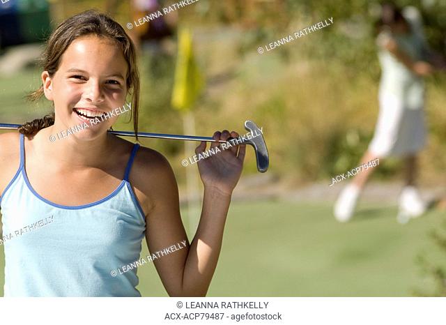 Girl 10-12 enjoys mini-golf at the Blackcomb Adventure Zone, Whistler, BC