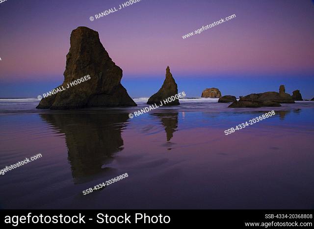 Full Moon Setting in Pre Dawn Light On With The Sea Stacks On Face Rock Beach in Bandon Oregon