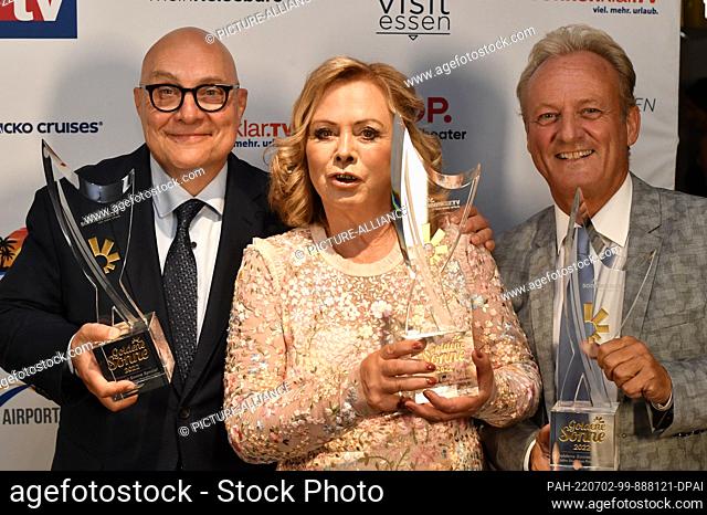 02 July 2022, North Rhine-Westphalia, Essen: Award winners in the ""Show"" category Thomas Koschwitz (l-r), Marijke Amado and Uwe Hübner show off their prizes...