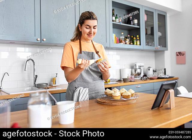 woman cooking food and baking on kitchen at home