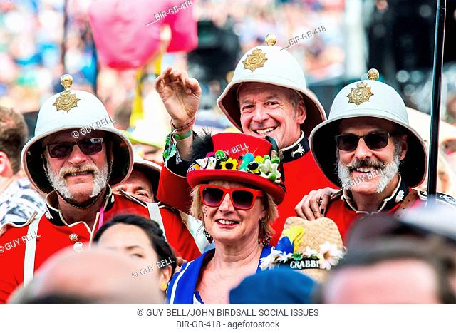 Redcoat soldiers in pith helmets watching Burt Bacharach on the Pyramid stage. The 2015 Glastonbury Festival, Worthy Farm, Glastonbury
