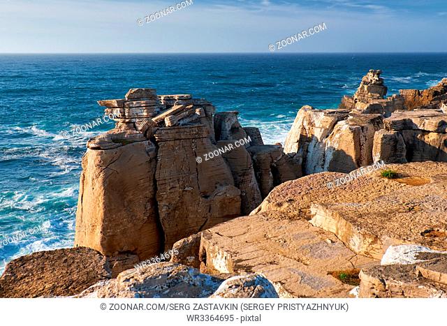 Rocks and waves of surf in the ocean near Cabo Carvoeiro (Cape of Coal), Peniche peninsula, Portugal
