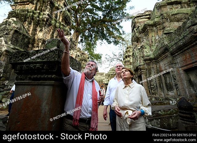 14 February 2023, Cambodia, Siemreab: German President Frank-Walter Steinmeier (center) and his wife Elke Büdenbender visit the Ta Prohm temple complex near...