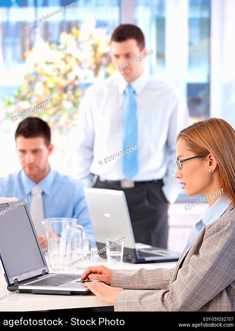 Young businesswoman and team working in bright office