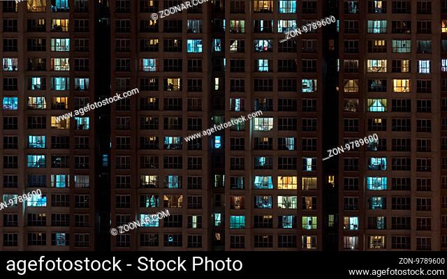 Lights in the windows of multistorey block of flats at night. Kuala Lumpur, Malaysia