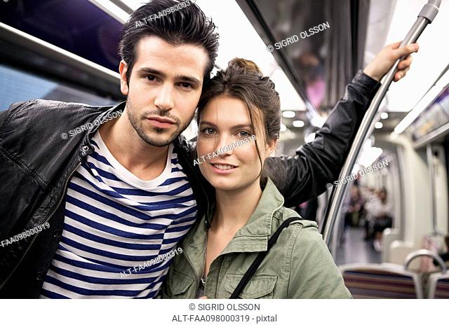 Couple on subway together, portrait