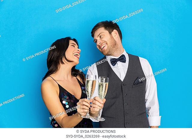 happy couple with champagne glasses at party
