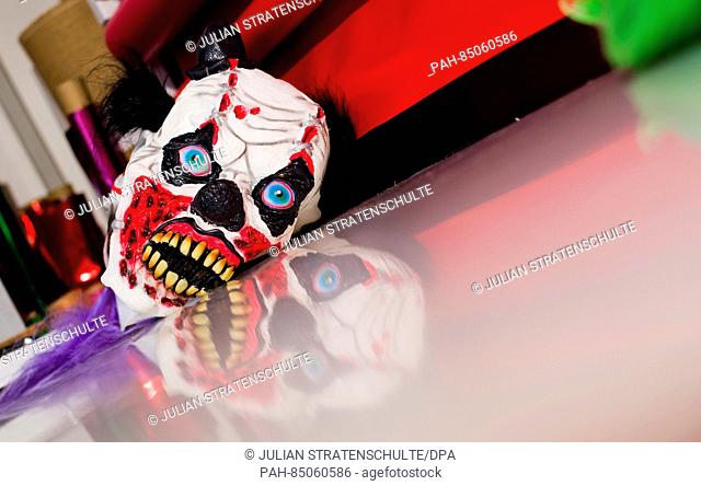 A clown mask lies on a table at 'Lutzmann Berger & Traupe, ' a specialty store for costumes and theatrical supplies in Hanover, Germany, 25 October 2016
