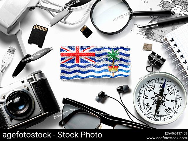 Flag of British Indian Ocean Territory and travel accessories on a white background. The view from the top