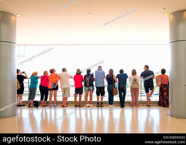 Panama City, Panama - march 2018: Group of tourist people from behind standing at balustratde looking at Panama Canal, Miraflores Locks, Panama City