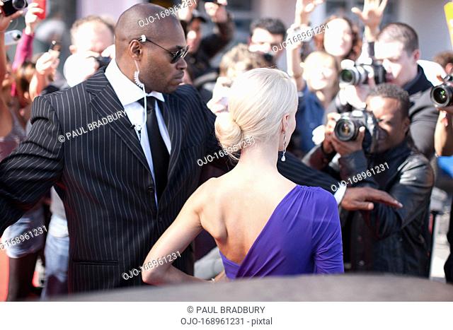 Bodyguard protecting celebrity on red carpet