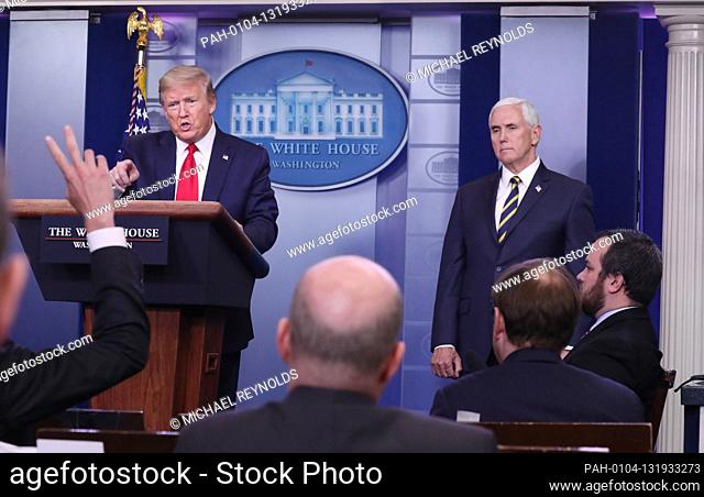 US President Donald J. Trump (L) and US Vice President Mike Pence (R) are joined by members of the Coronavirus Task Force