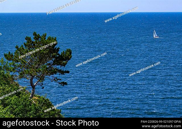24 July 2022, Denmark, Vang: A sailboat sails on the blue Baltic Sea off the Danish island in the Baltic Sea. The island of Bornholm is - together with the...