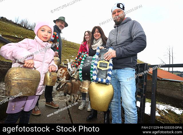 29 December 2021, Bavaria, Rettenberg: Landlords Peter Soyer (2nd from left) and Angelika Soyer (2nd from right), as well as neighbours and holiday guests ring...
