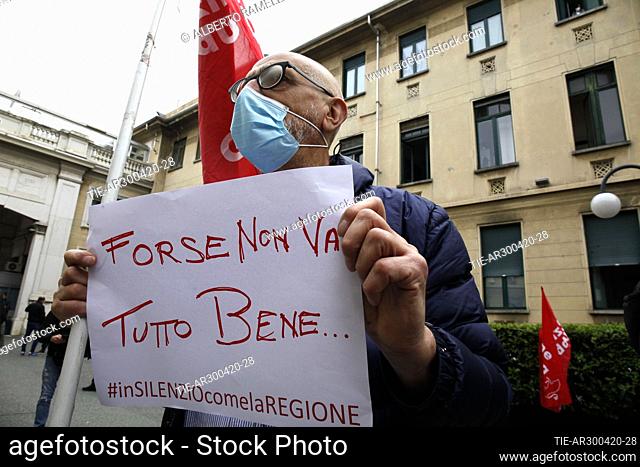 Protester shows the banner with phrase ' maybe it's not all right' under the Molinette hospital, health workers report the absence of suitable individual...