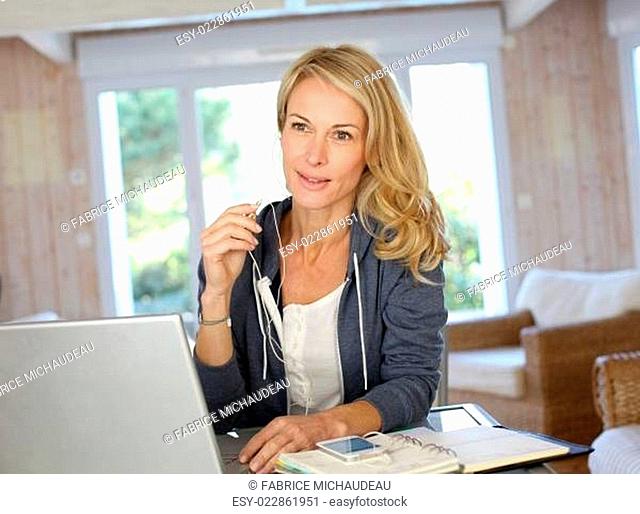 Attractive middle-aged woman working at home