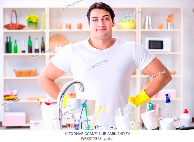 Good husband washing dishes at home