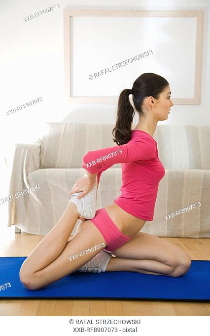 young woman doing streaching exercising