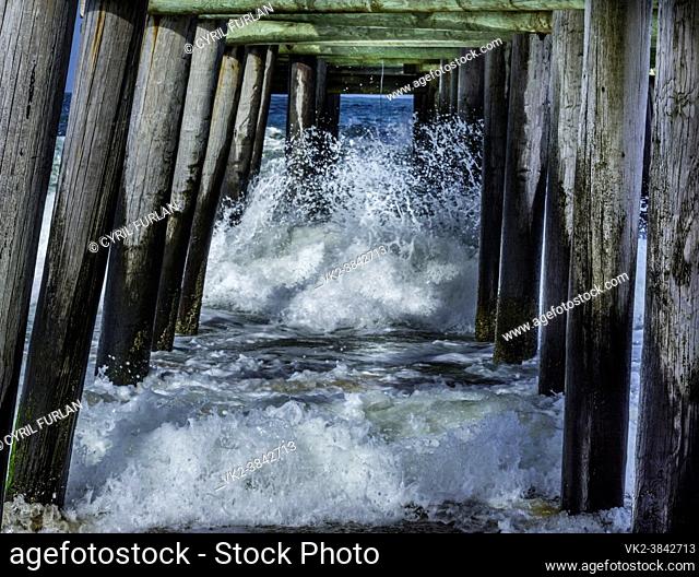 Waves hitting pier jutting out into the Atlantic Ocean, Virginia
