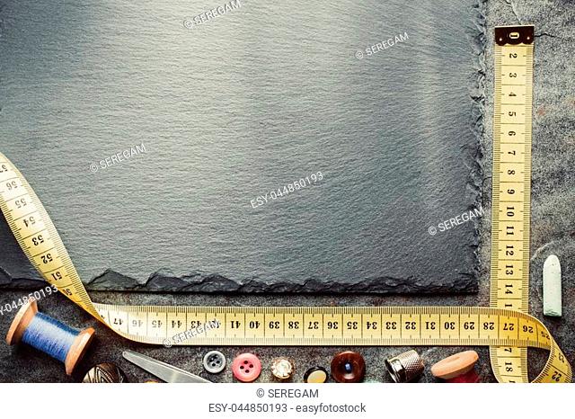 sewing tools and measuring tape on table background