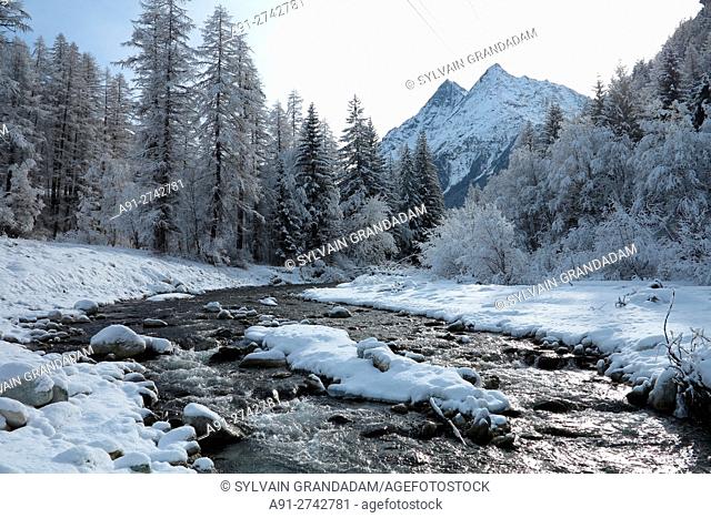 Switzerland, Valais, Val d'Herens, village of Evolene in winter, hiking along river Borgne