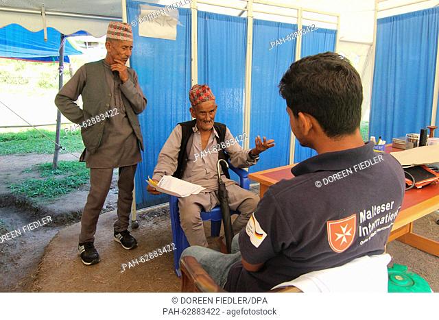 Dambar Bahadru Paraguli (C, 83) gets advice at the medical center of the Malteser relief organzation in Lamosanghu, Nepal, 19 October 2015