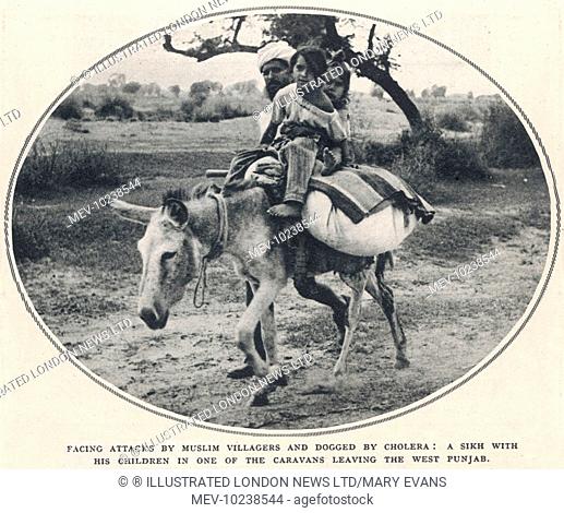 A Sikh man with his children in one of the caravans leaving the West Punjab region for the comparative safety of the East Punjab