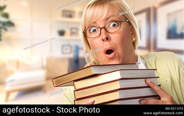 Beautiful expressive student or businesswoman with books in office
